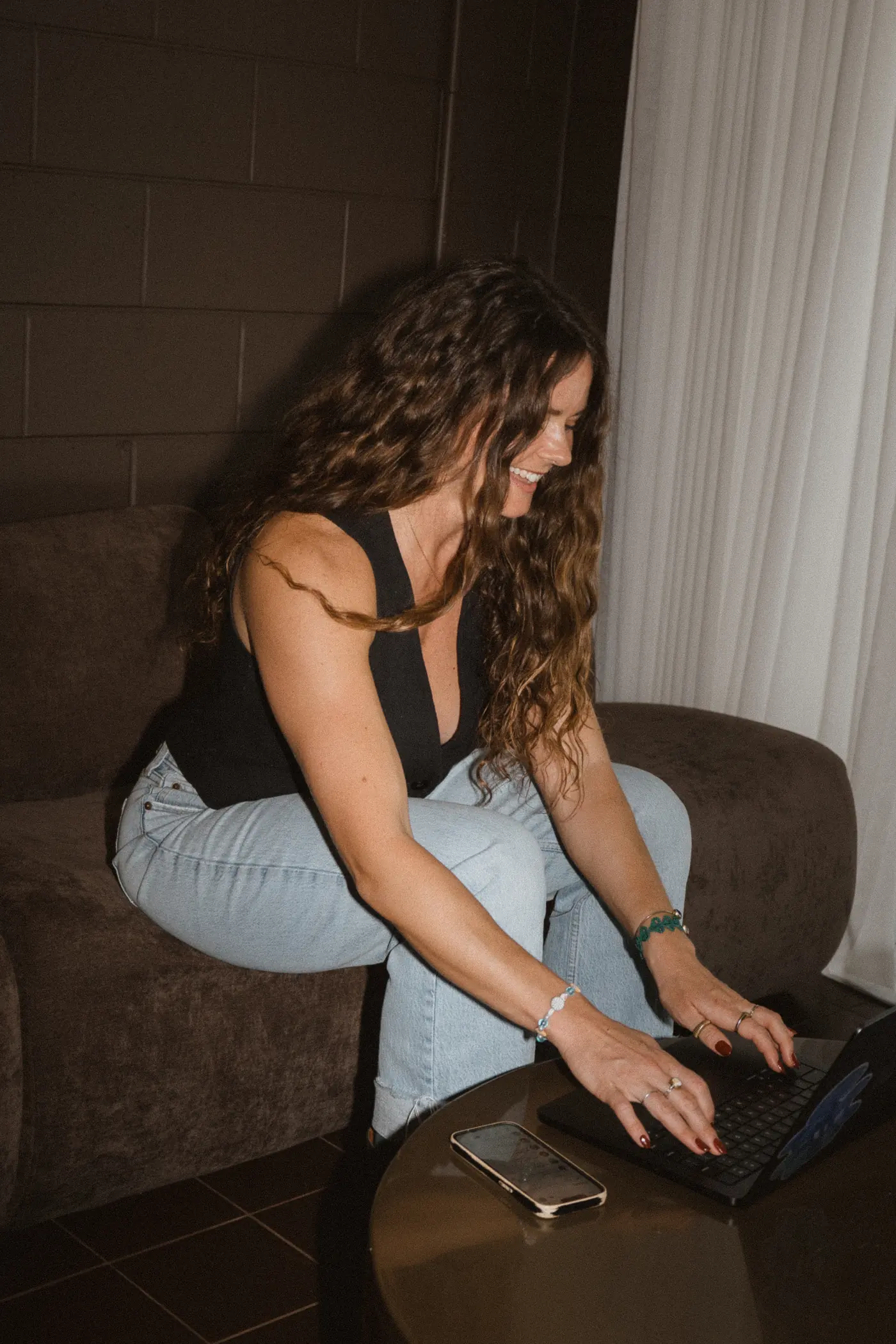 Amy smiling as she works on her laptop