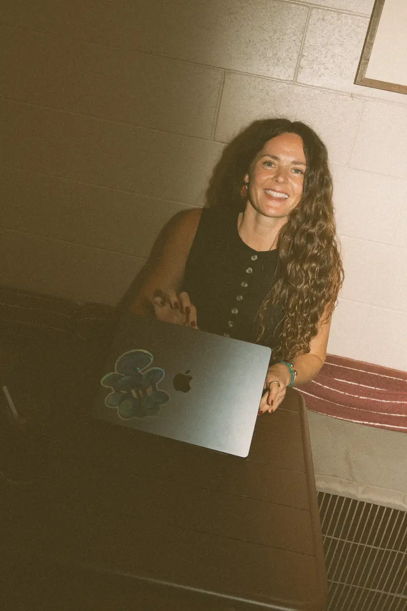 Amy smiling at her laptop, working on an email campaign